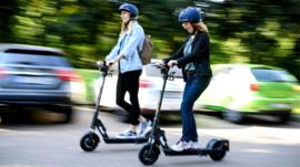 Women riding electric scooters in Germany